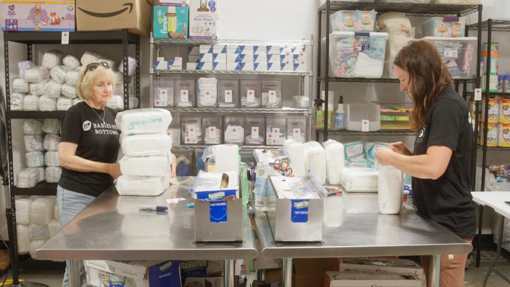 Volunteers at Babies Need Bottoms wrapping diapers